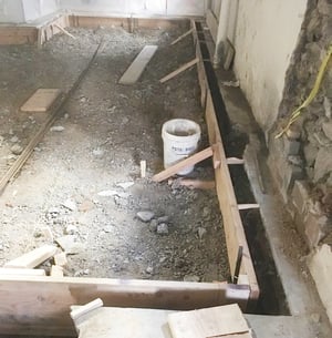 Basement remodel showing masonry curbing to increase ceiling height