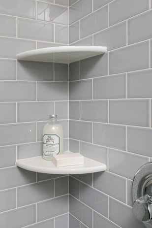 Two Shelves in Shower with Shower Products on Them