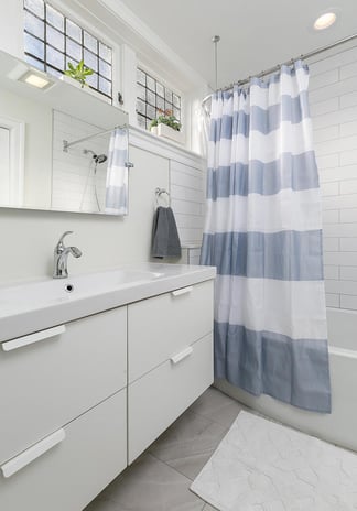 Sink with Striped Shower Curtain Next to It