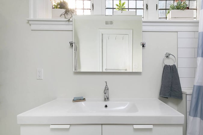 White Sink with Small Mirror Above
