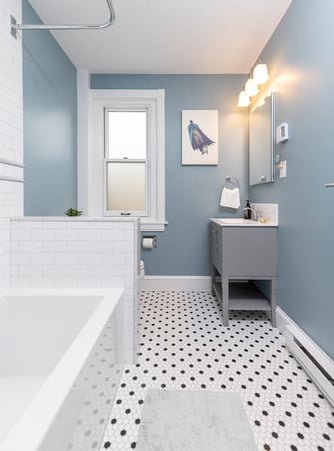 A Wonderful Grey Accented Bathroom Featuring Black and White Tile and Grey Sink