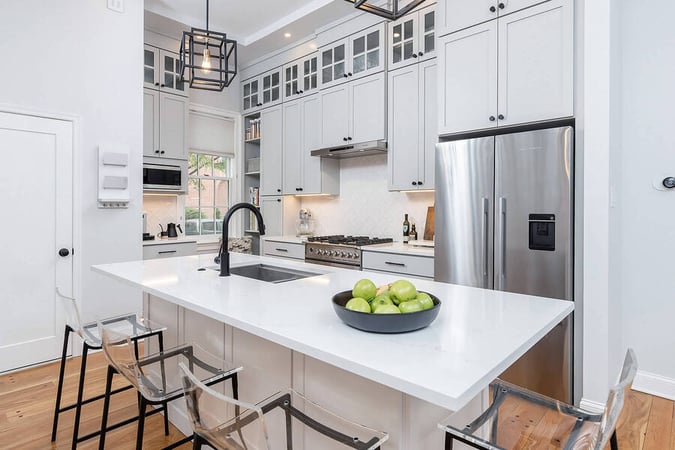 Beautiful white kitchen island with built-in sink by Bellweather Design-Build in Philly