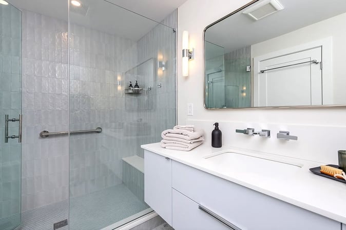 White transitional bathroom with white vanity and walk-in shower by Bellweather Design-Build in Philly