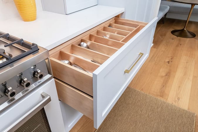 White wooden drawer in transitional kitchen with separate wood sections for silverware by Bellweather Design-Build in Philly
